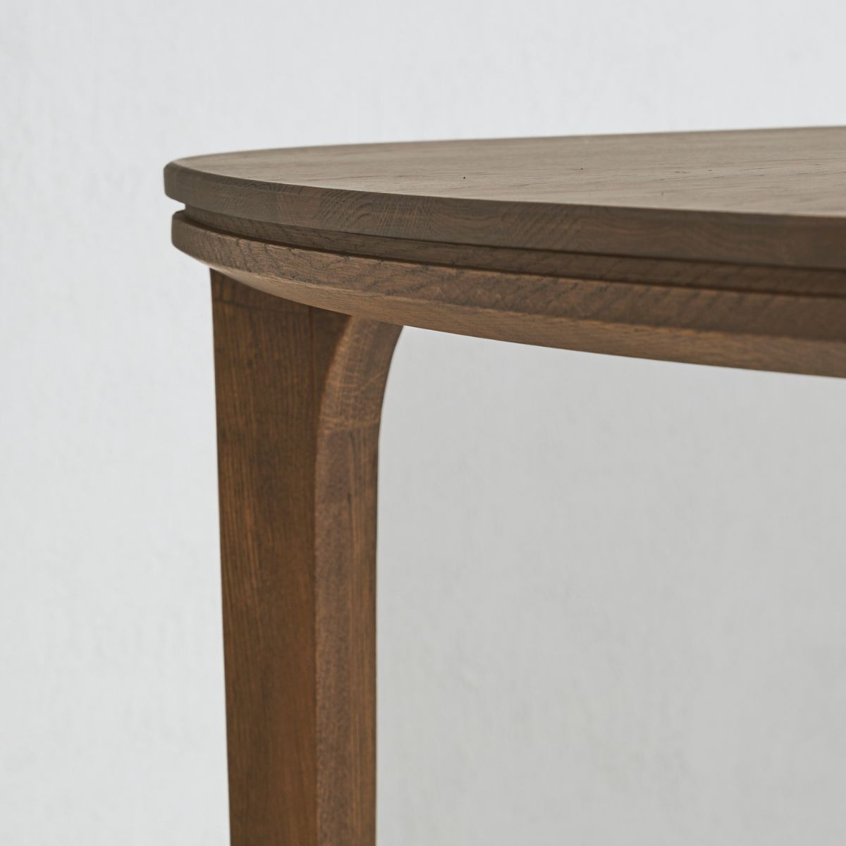 SEVA oak dining table with sculptural form and soft rounded edges