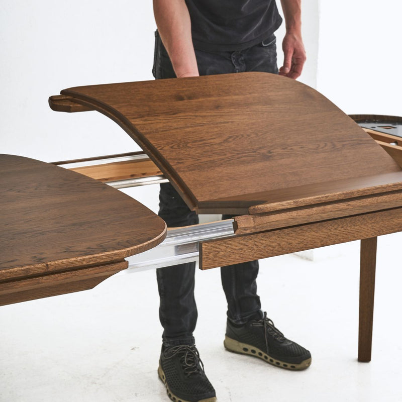 Modern solid oak table SEVA featuring smooth organic design