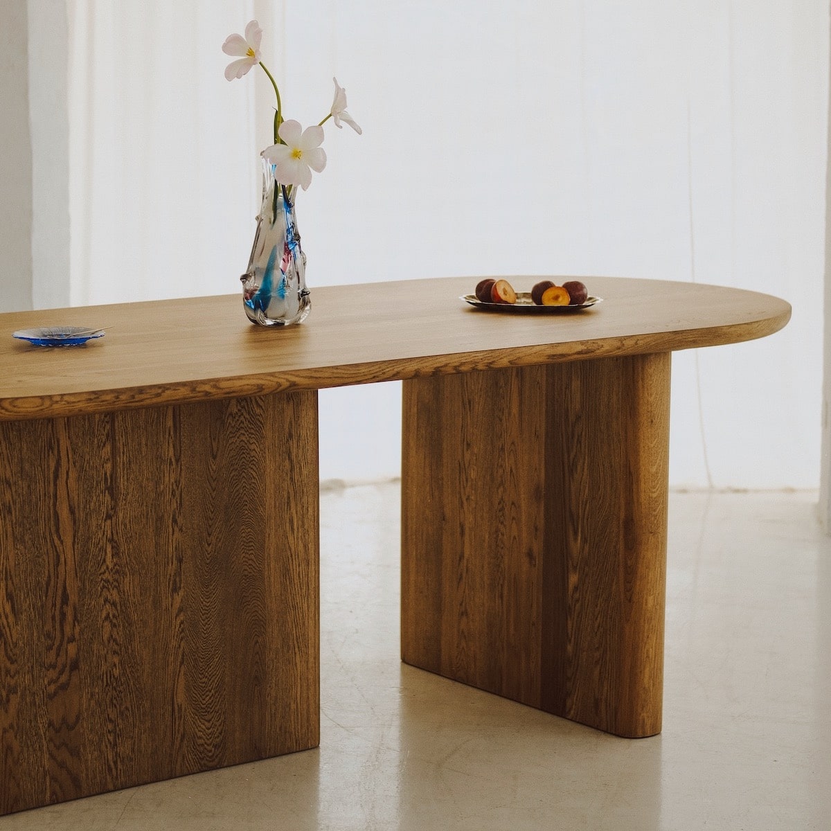 Round view of KAZA solid oak table with warm tone