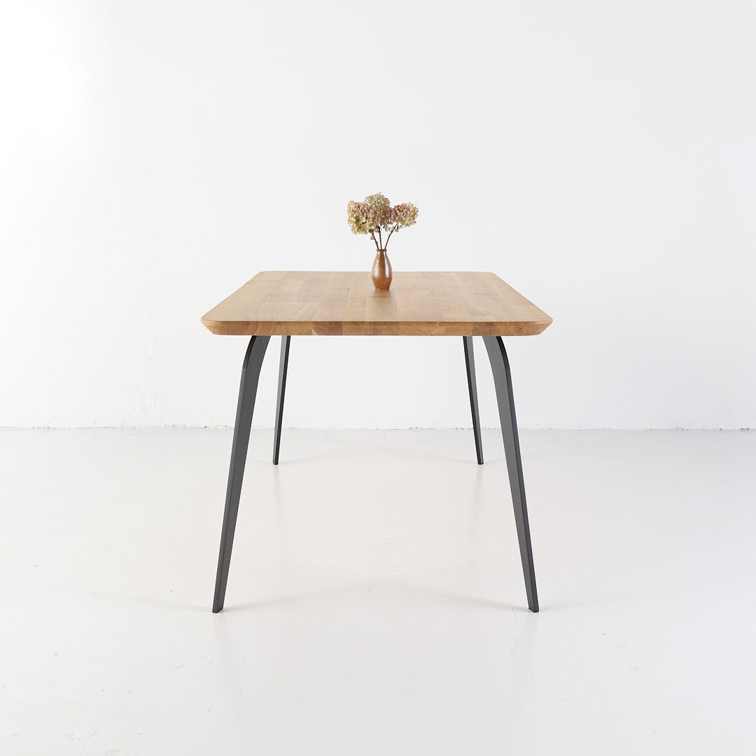 Handcrafted ST 2 dining table made from solid oak with black steel legs