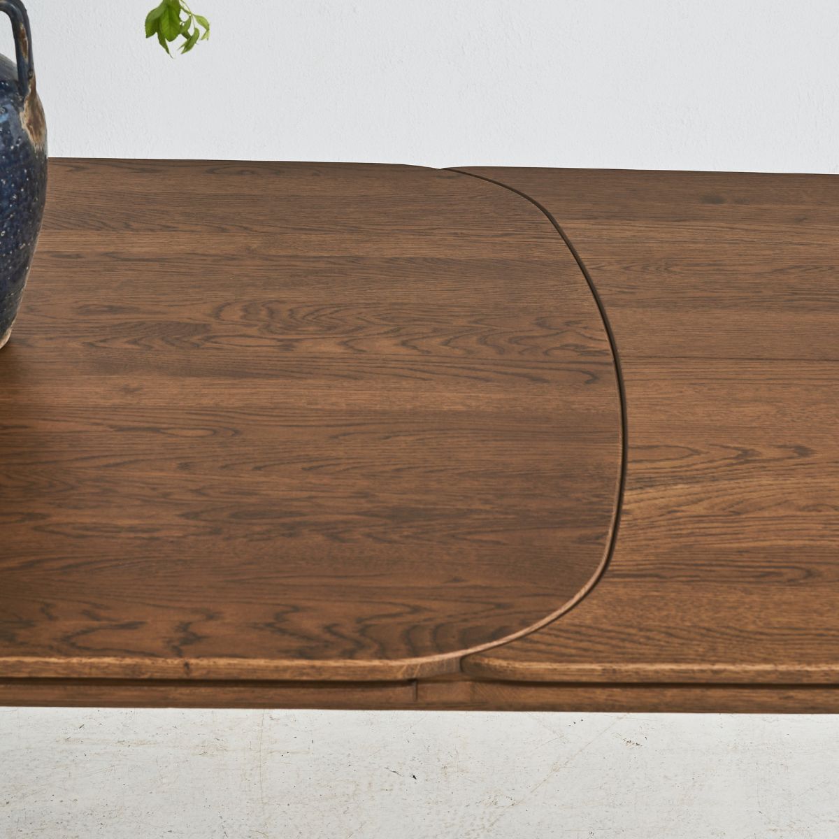 Contemporary SEVA dining table with bold curved design in oak wood