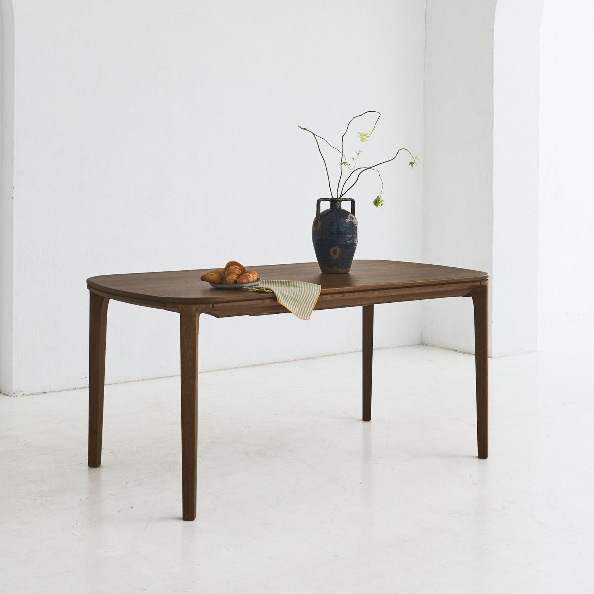 Contemporary SEVA dining table with bold curved design in oak wood
