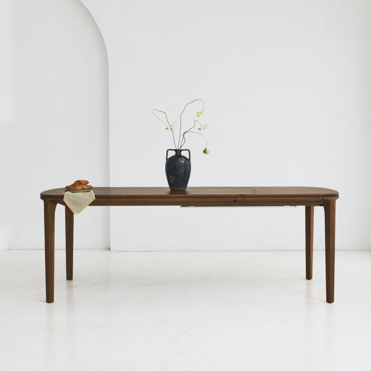 SEVA oak dining table with sculptural form and soft rounded edges